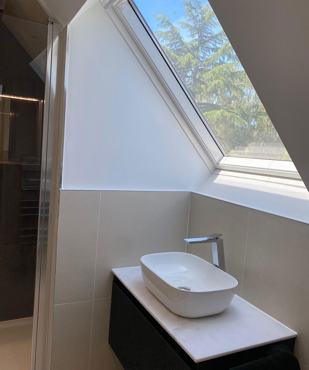 Bathroom with a sloped ceiling and a wall-hung basin