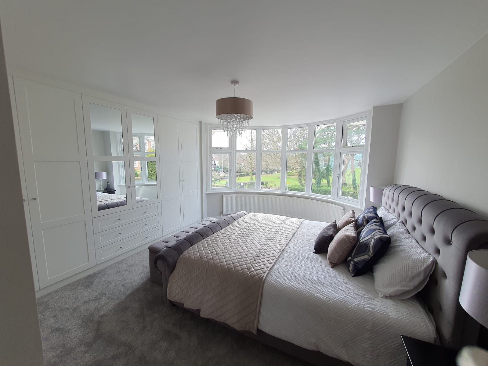 Renovated bedroom with a bay window and new flooring