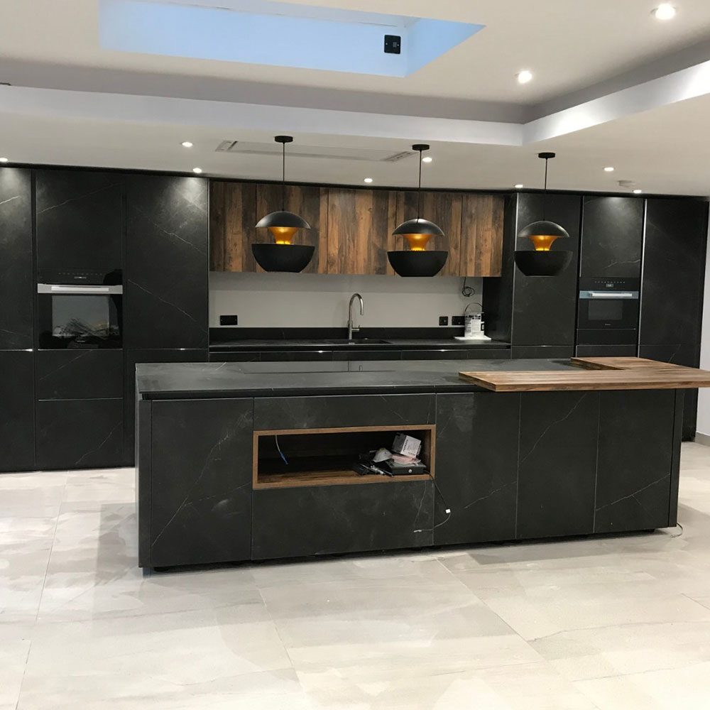 Contemporary black kitchen with a large island and integrated appliances