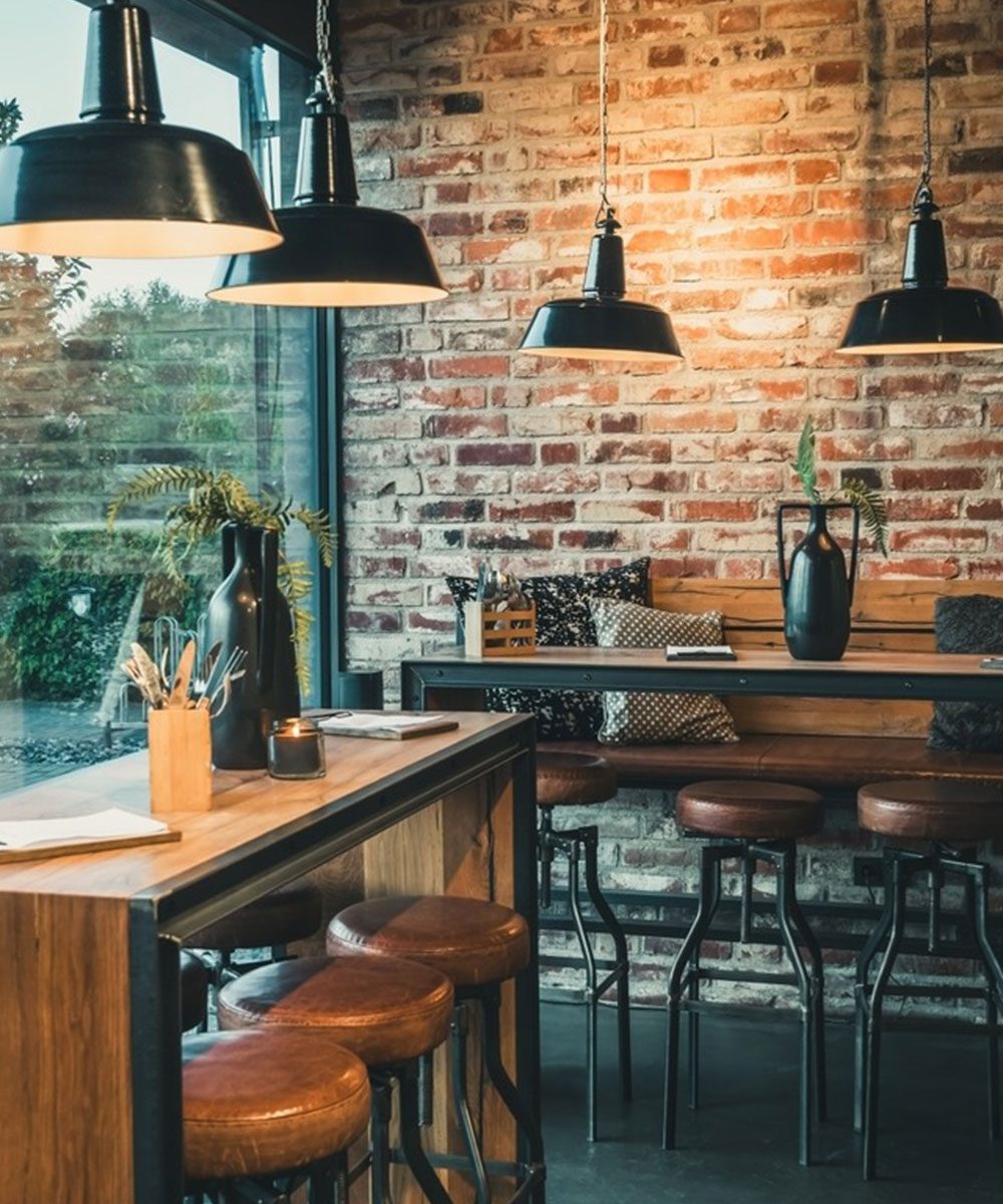 Cafe and bar fit out with brickwork, a timber counter and stools