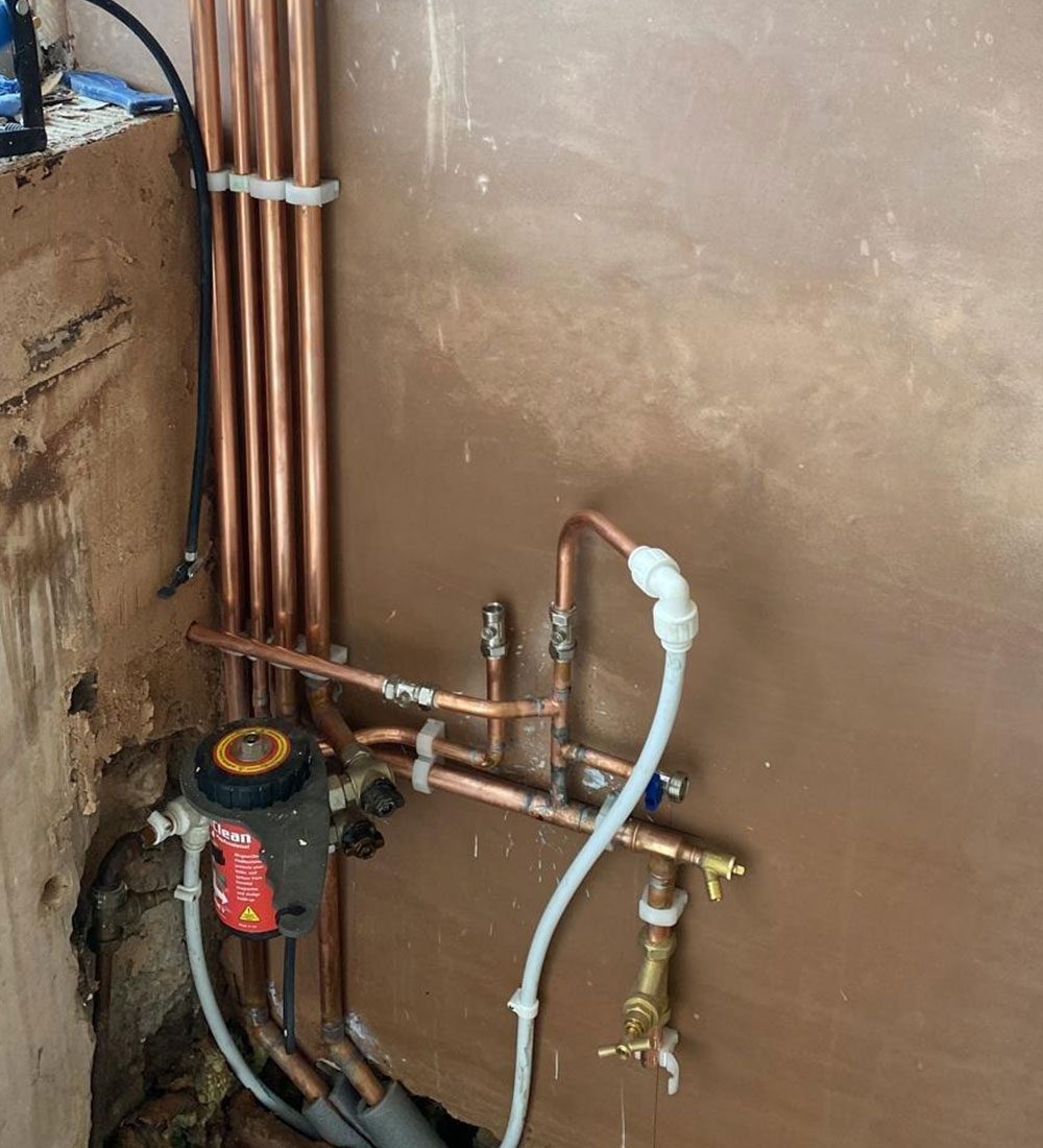 New copper pipework installed in a wall chase