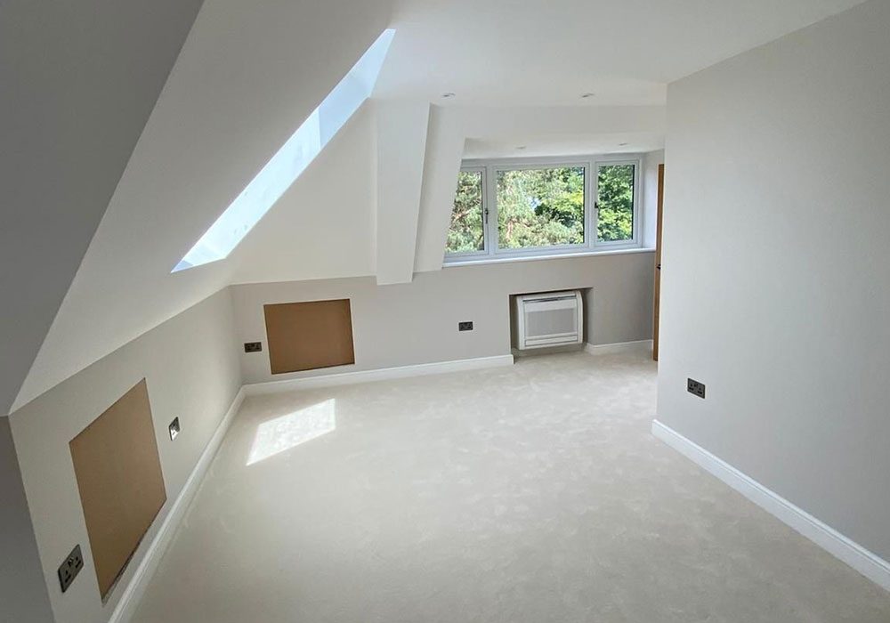 Loft conversion with a roof window and finished plaster