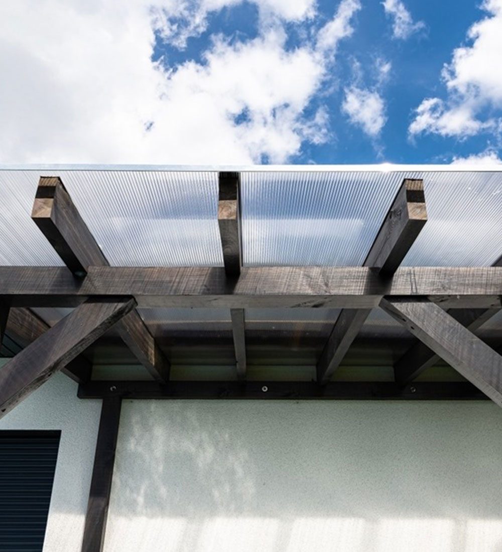 Roof structure viewed from below against an open sky