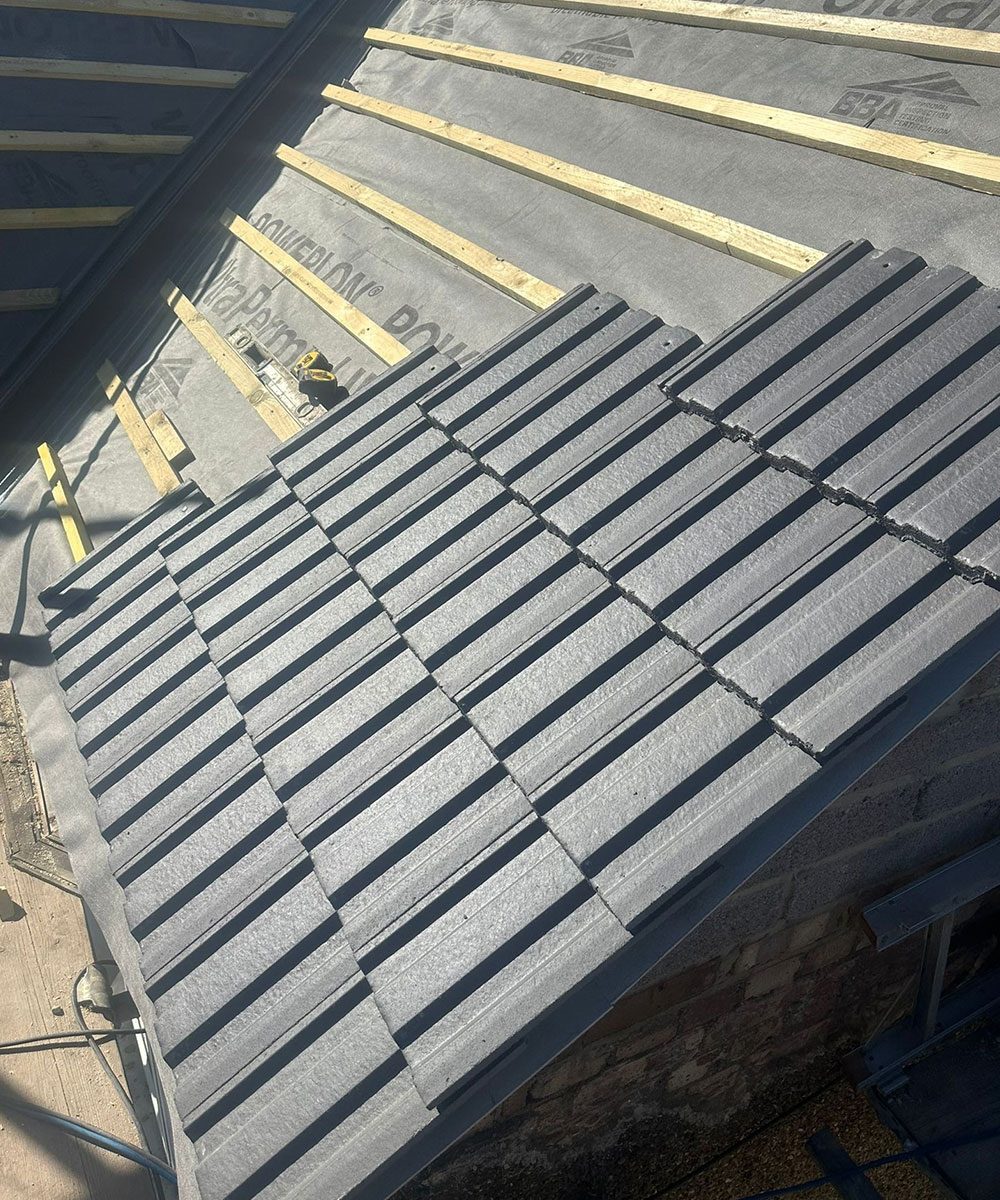 Roof tiling in progress on a pitched roof