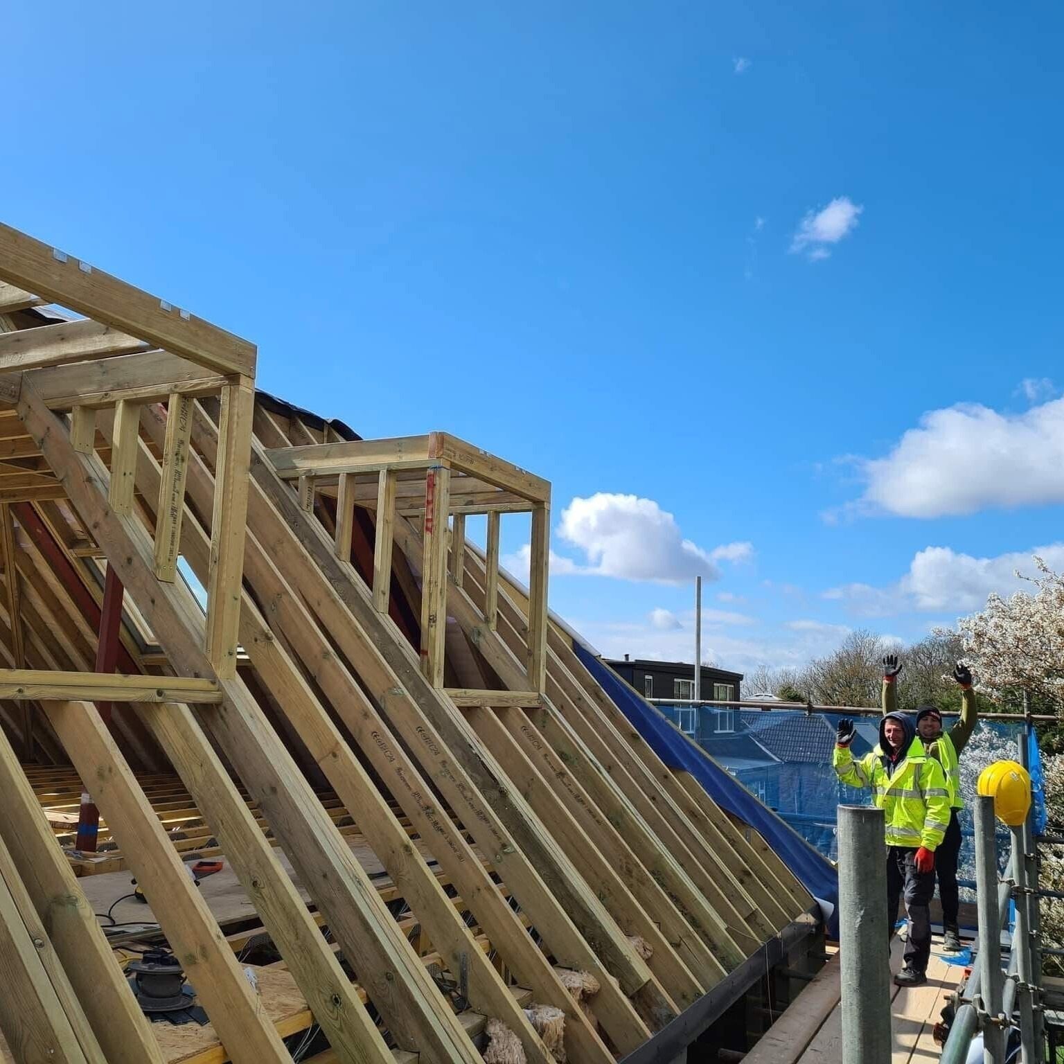 Roof timbers and scaffolding during construction, with the site team on the scaffold