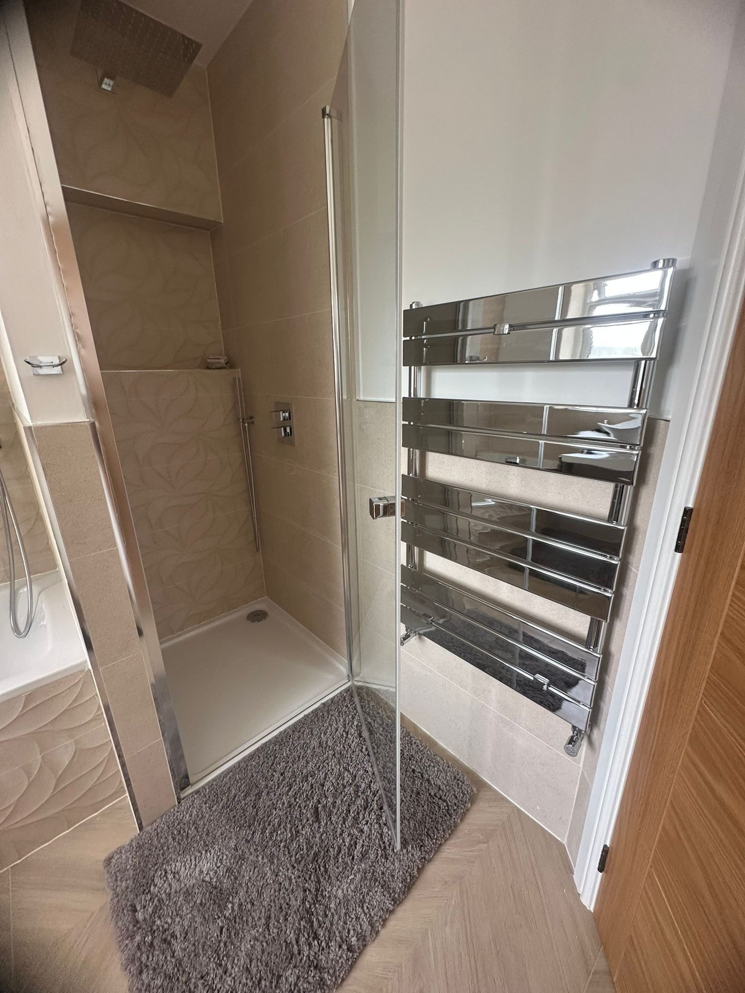 Shower room with a glass screen and a towel radiator