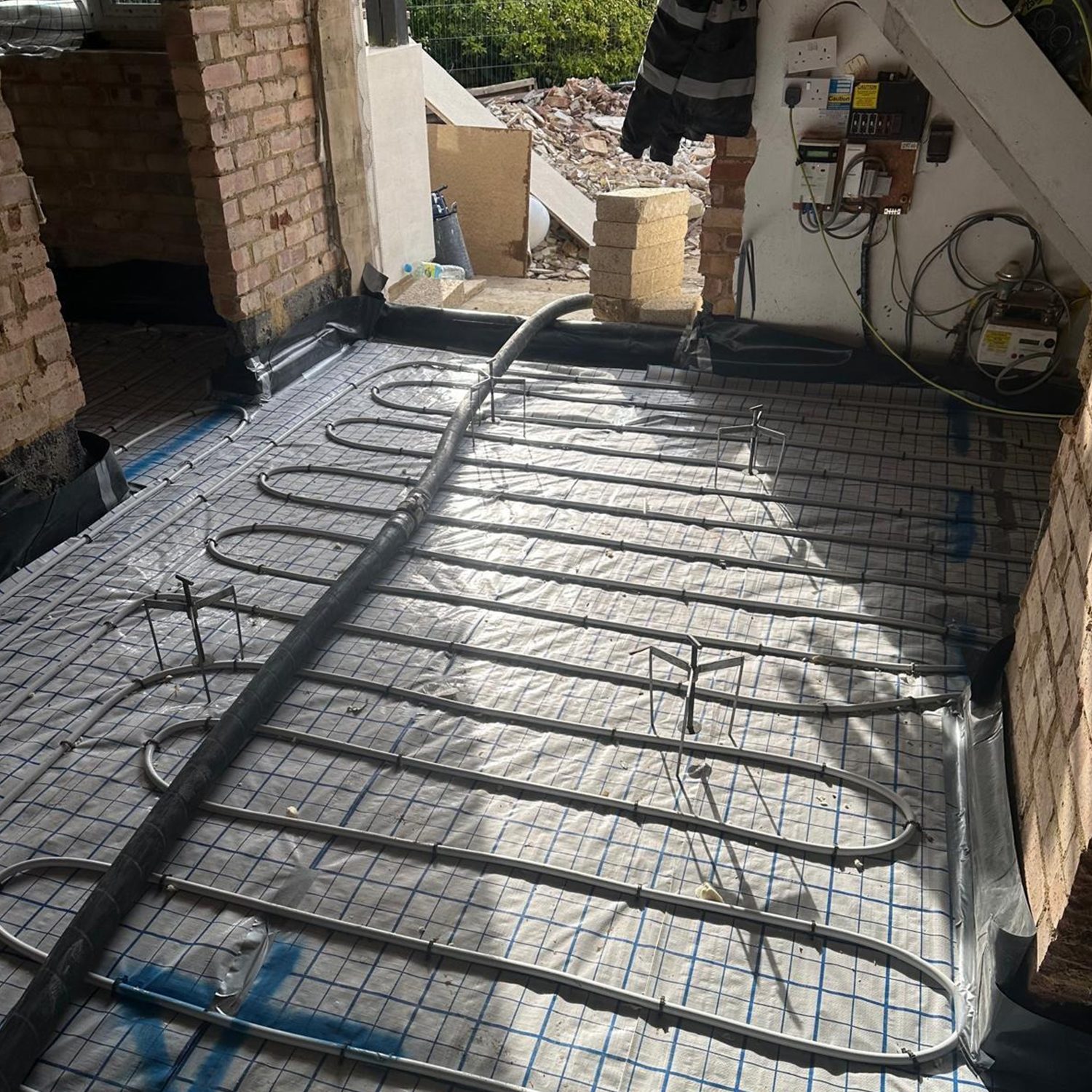 Underfloor heating pipework laid across a new floor before screeding